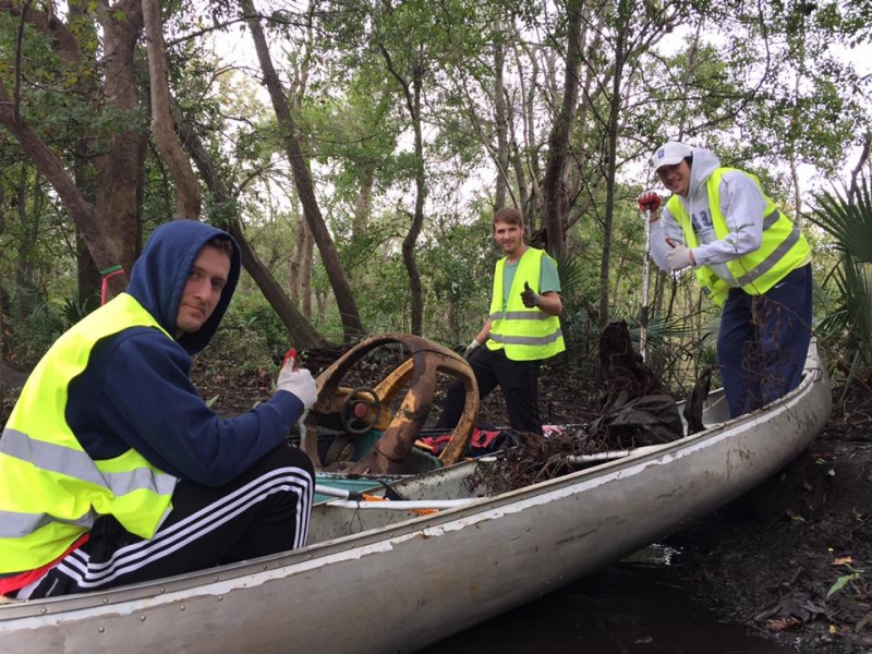 Men in a boat giving a thumbs up.