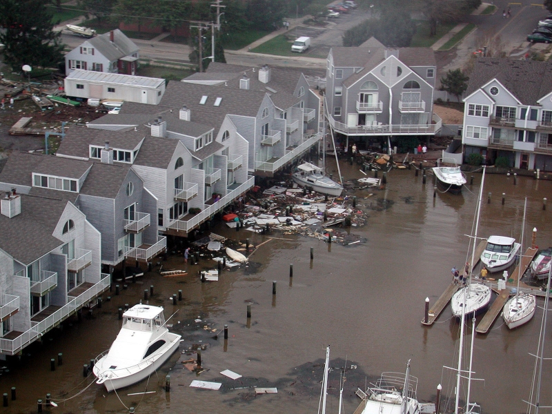 Boats and other debris in the water near homes.