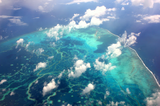 View of a coral reef from the air with clouds