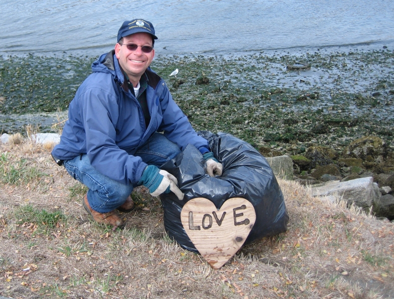 Man with plywood heart that says "love".