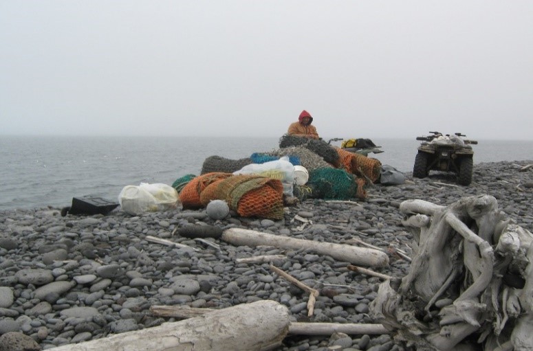 A person hauling collected debris using an ATV.