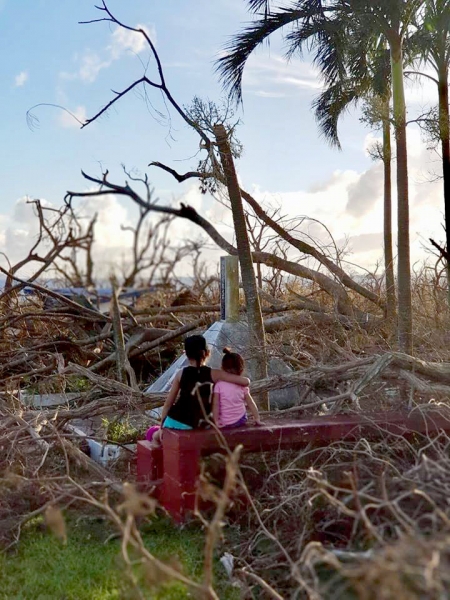 Two sisters observe the aftermath of Typhoon Yutu in the Mariana Islands.