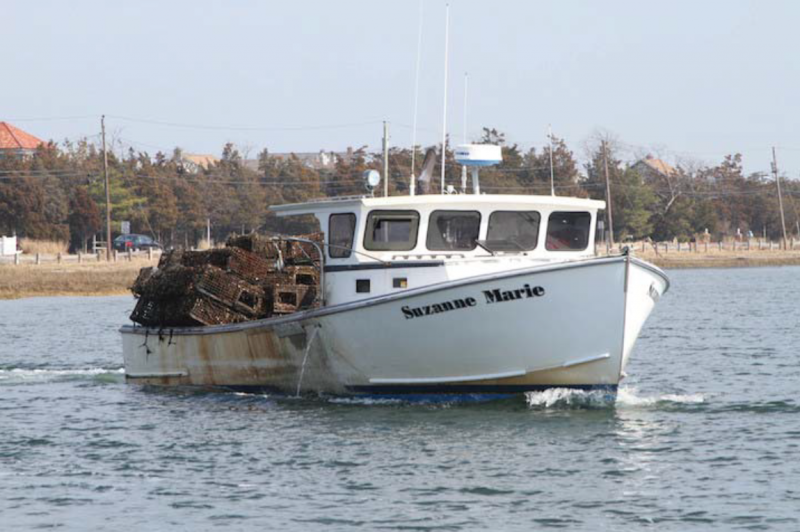 A boat hauling collected derelict/abandoned gear back to shore.