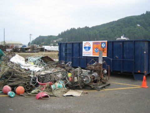 A Fishing for Energy bin with gear next to it.
