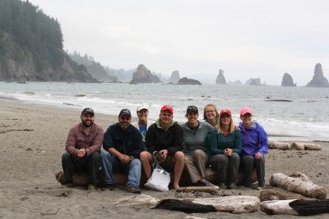 Group of people sitting on the beach.