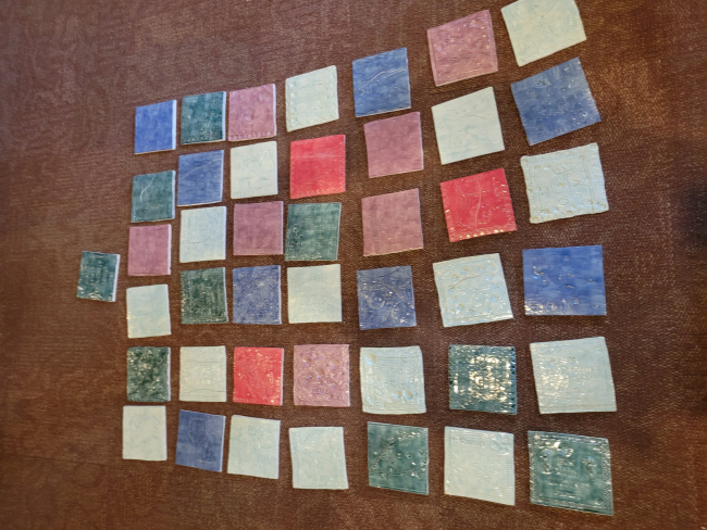Rows of colorful clay tiles on the floor.