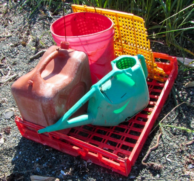 Large plastic debris including jugs and buckets.