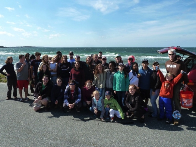A group photo of a beach cleanup crew.