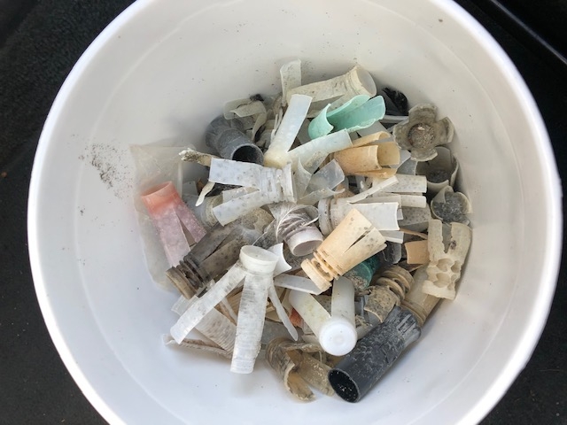 A bucket of collected shotgun wads.
