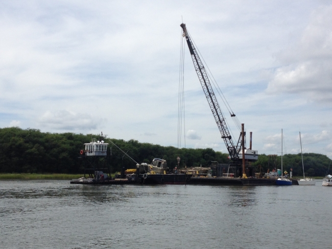 A motorboat being removed with a crane.