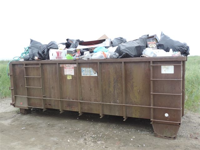 A dumpster filled with trash.