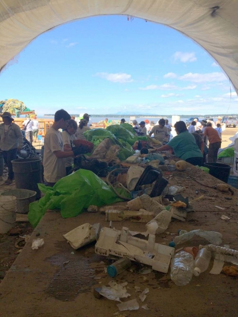 People among piles of debris, sorting it.