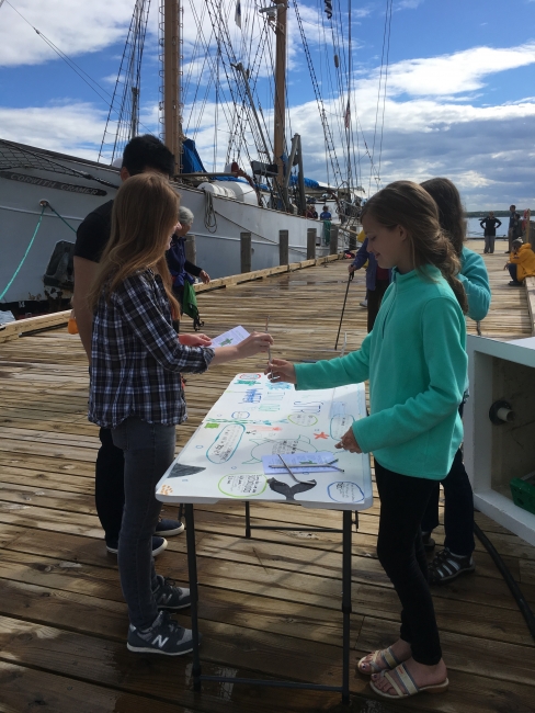 Students at an outreach table.