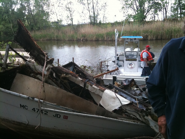 A derelict vessel that has been brought onto shore after being removed from the water.