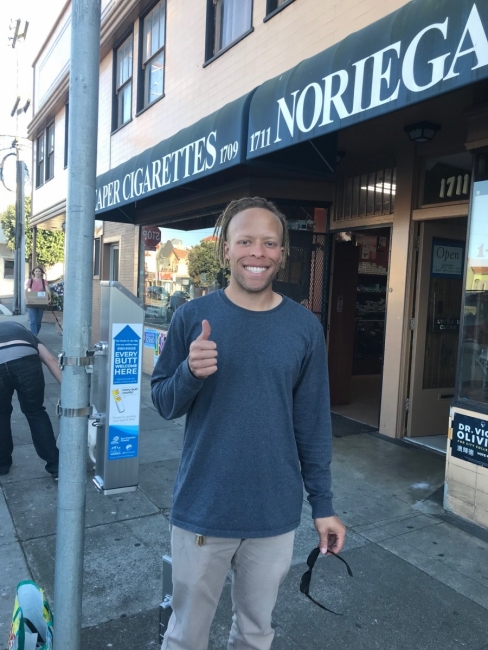 A volunteer installing a cigarette buttcan in San Francisco.