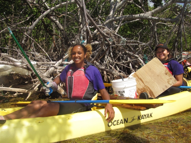 Two volunteers in kayaks.