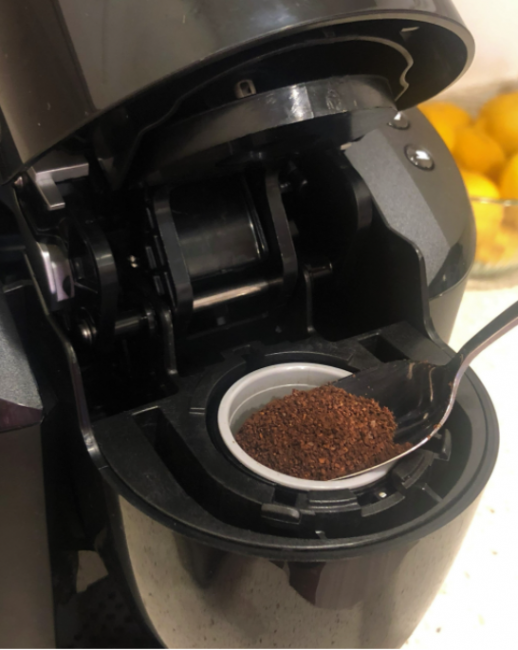 A reusable instant coffee pod being refilled.