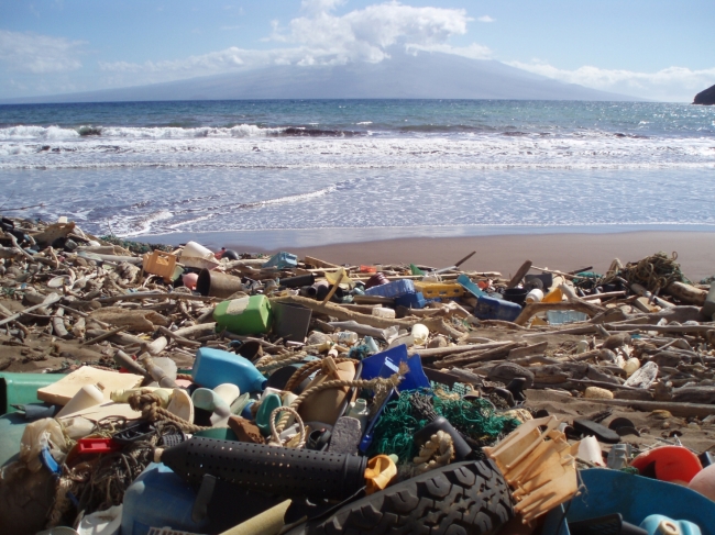 Marine debris, including plastic detergent bottles, crates, buoys, combs, and water bottles blanket Kanapou Bay, on the Island of Kaho‘olawe in Hawaii. This region is a hot-spot for marine debris accumulation. Because of its remote location, removal is difficult, resulting in beaches that look more like a landfill.