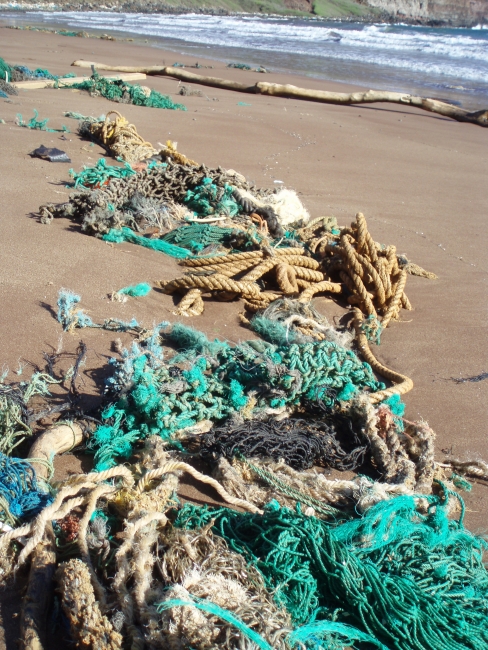 Derelict nets and ropes on a beach.