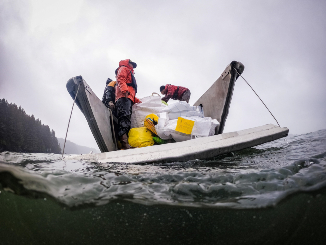 A small boat with marine debris loaded in it. 