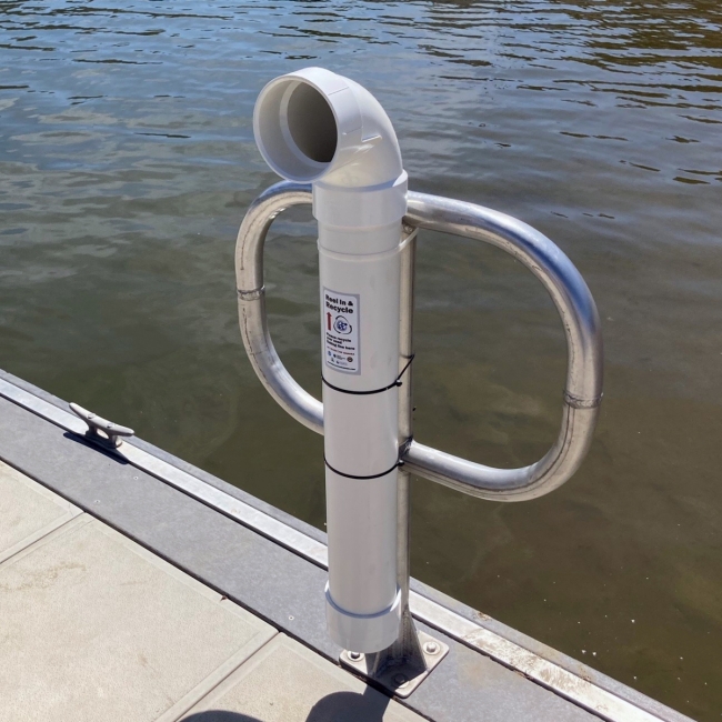 A fishing line recycling bin installed near the water on a reservoir dock.