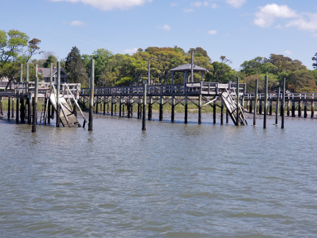 Damaged docks beginning to fall apart into the water.