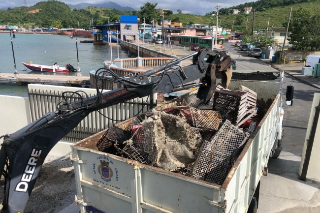 Derelict fishing gear being loaded onto a truck.