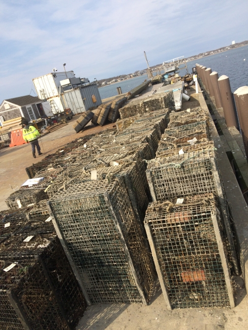 Collected derelict fishing gear sits on a dock.