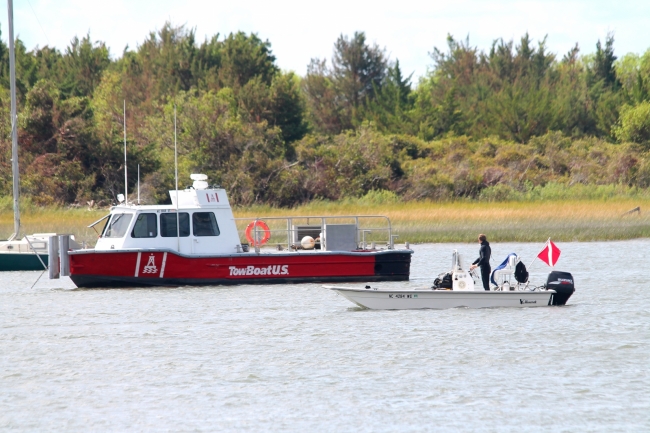 A dive crew from Atlantic Coast Marine Group-TowBoatUS retrieves underwater debris from Taylors Creek in Beaufort.