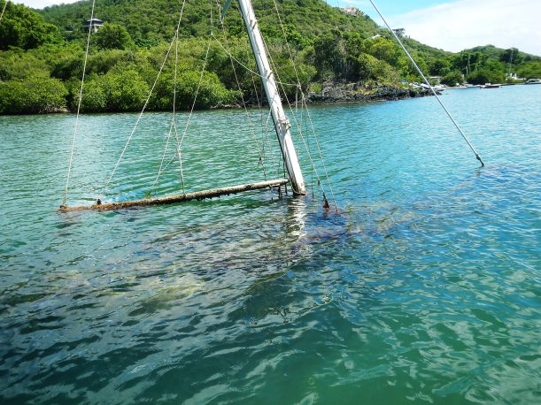 A derelict vessel submerged in water.