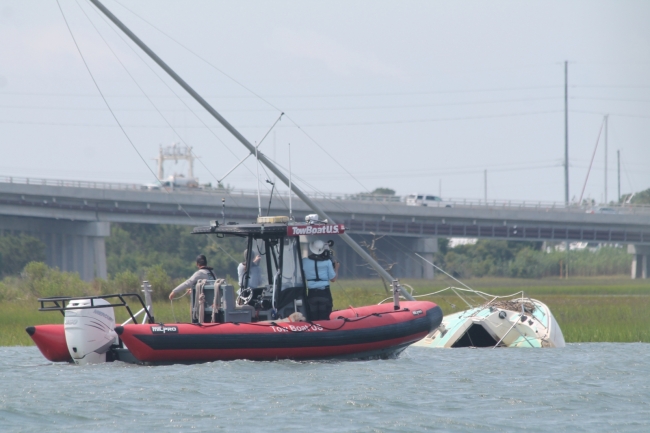 BoatUS Foundation, with assistance from North Carolina Coastal Reserve interns and TowBoatUS, film an assessment of an abandoned vessel.