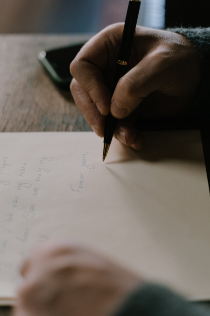 A person writing a letter.