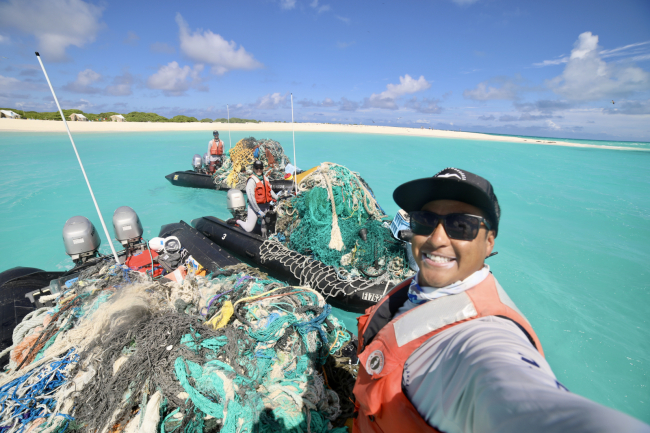 Three marine debris boats fully loaded with removed marine debris.