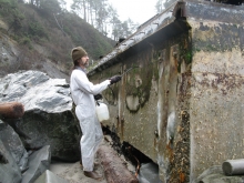 A worker sprats a piece of concrete. 