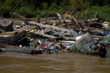 Logs and debris blocking a river.