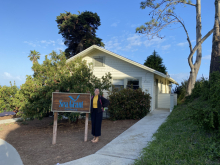 Tanya smiles next to the California Sea Grant sign. 