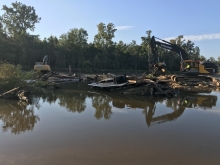 heavy machinery on the banks of a river. 
