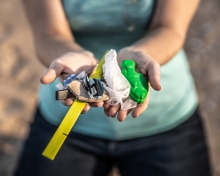 Scooped hands holding out marine debris.