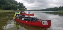 Volunteers paddle in removed marine debris. 