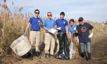 People posing with debris they have collected. (Photo Credit: American Littoral Society)