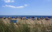 Several people relax on a beach.