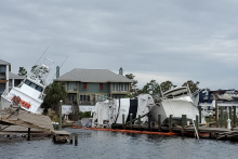 Vessels and a dock left damaged after a hurricane.