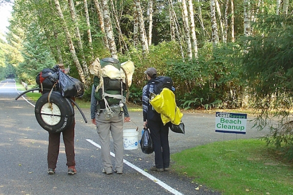 Three people hauling debris.