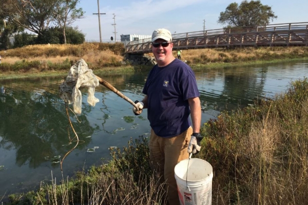 A volunteer holding up debris.