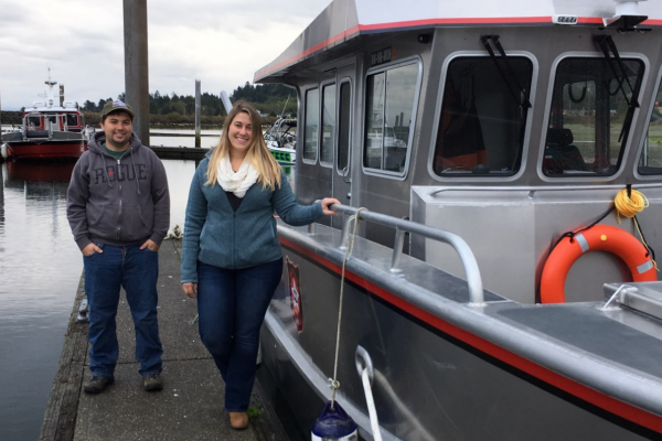 Makah Tribe project managers pose with the Tribal Enforcement Vessel.